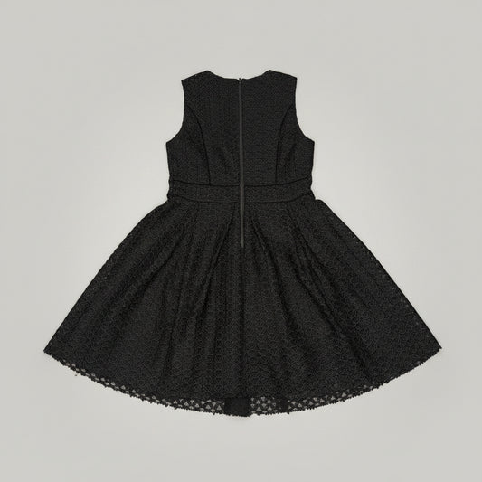Black lace dress on a patterned fabric background