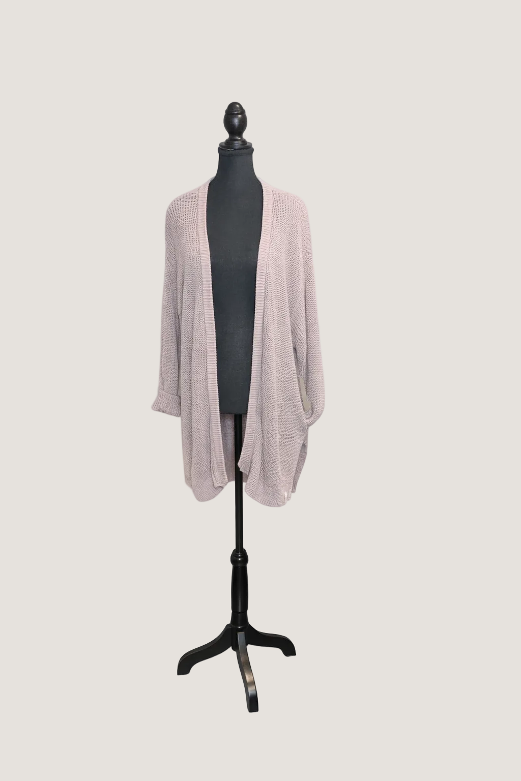 Beige cardigan on a mannequin with 'Curated Revival' branding on a white background