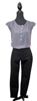 Mannequin wearing a gray blouse with white buttons and black pants against a plain background