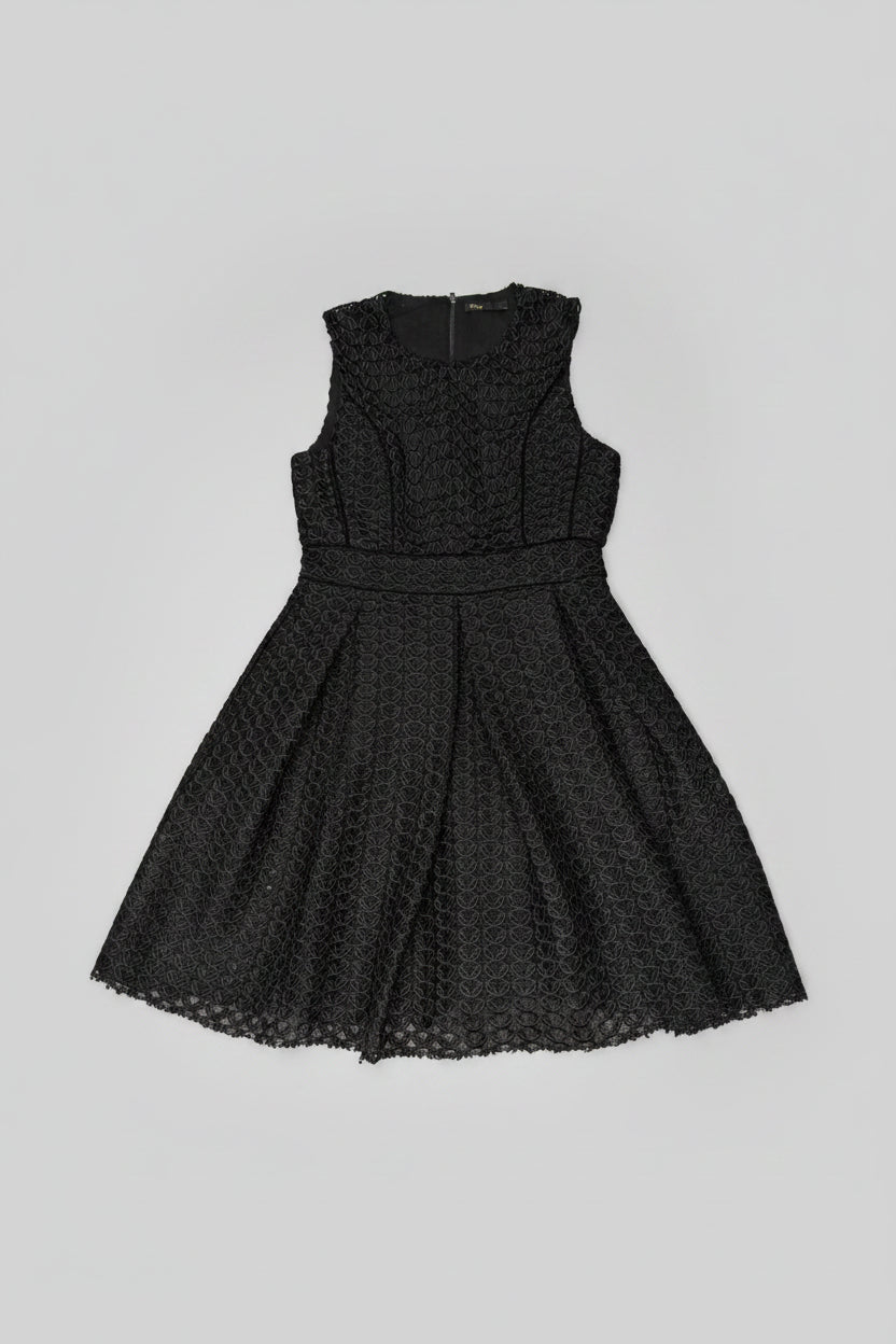 Black lace dress on a textured surface