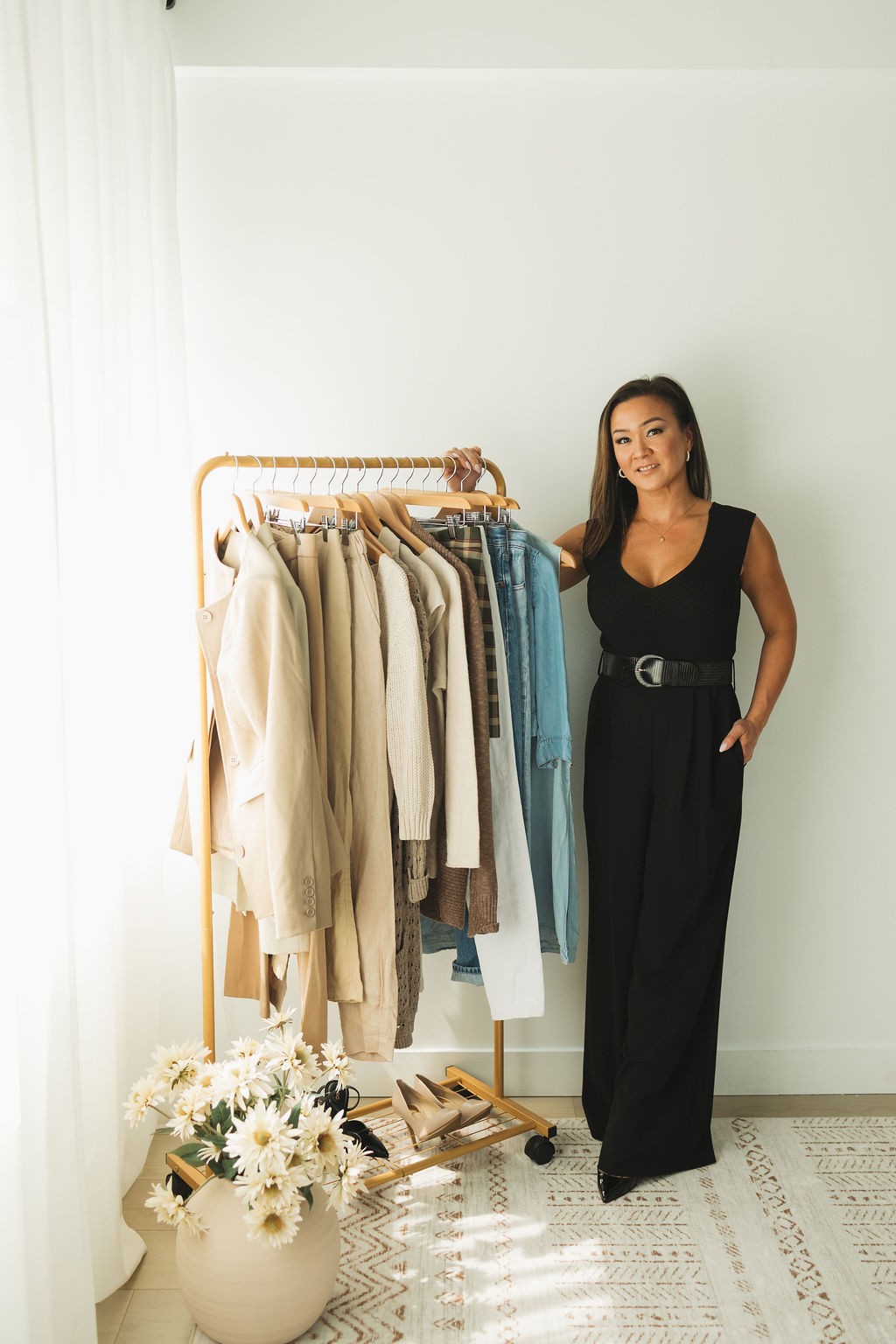 Curated Revival founder beside a curated clothing rack