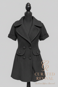 Black coat on a mannequin with 'Curated Revival' branding on a beige background